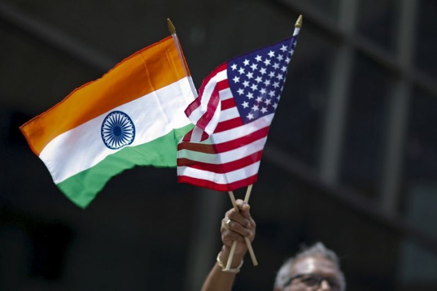 A man holds the flags of India and the US while people take part in the 35th India Day Parade in New York, US on August 16, 2015 — Reuters/Files