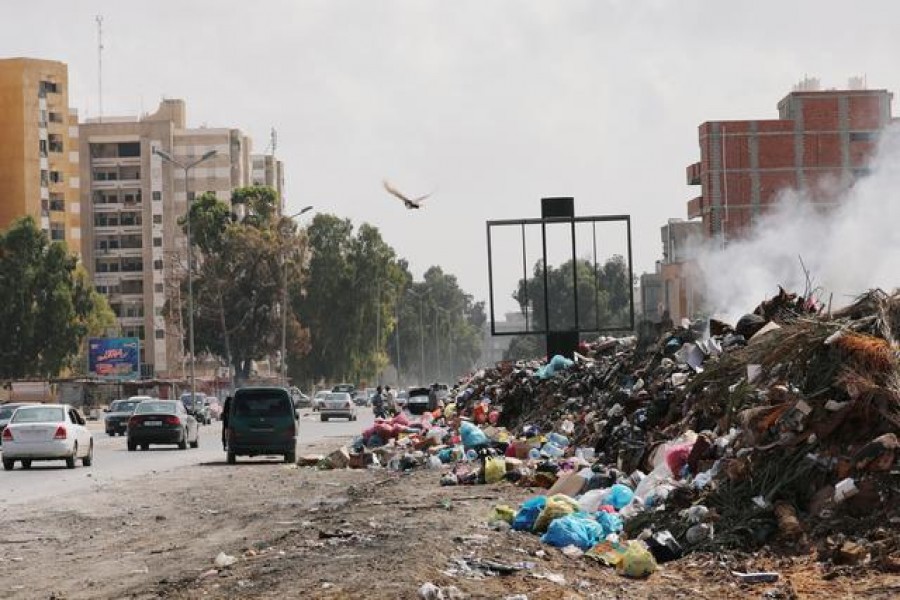 Cars pass next to the mounds of rubbish in Tripoli, Libya, October 12, 2019 — Reuters/Files