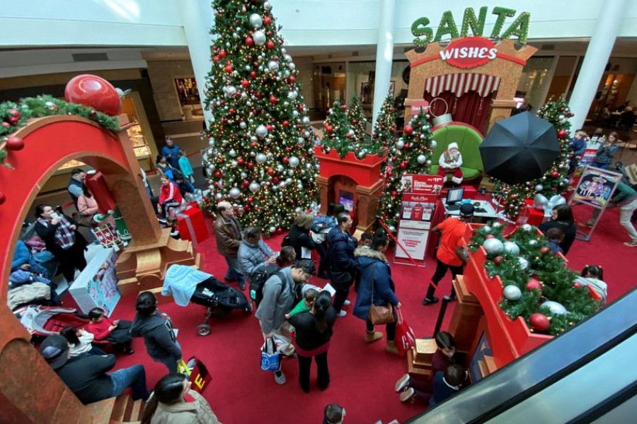 Families wait in line to meet Santa Claus at Fashion Centre at Pentagon City, decorated for the holidays, in Arlington, Virginia, US, December 23, 2019. REUTERS/Jonathan Ernst/File Photo