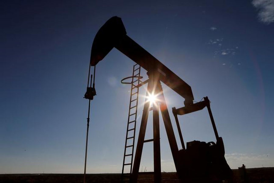 FILE PHOTO: The sun is seen behind a crude oil pump jack in the Permian Basin in Loving County, Texas, US, November 22, 2019. REUTERS/Angus Mordant/File Photo