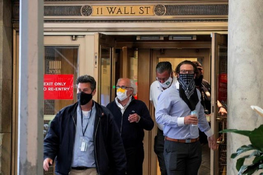 Traders exit the 11 Wall St. door of the New York Stock Exchange (NYSE) in New York City, New York, US, June 26, 2020 — Reuters