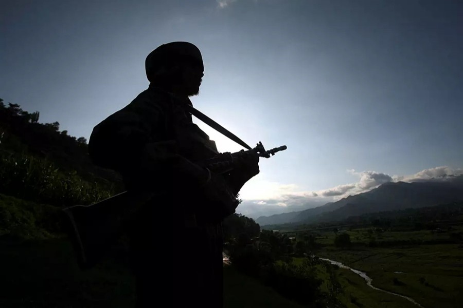 An Indian army soldier stands guard while patrolling near the Line of Control, a ceasefire line dividing Kashmir between India and Pakistan, in Poonch district on August 7, 2013 — Reuters/Files