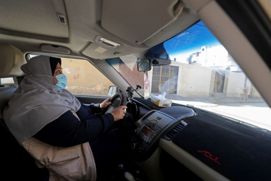 Palestinian woman Naela Abu Jibba, who started a women-only taxi service in Gaza Strip, drives her vehicle at Beach refugee camp in Gaza City Nov 17, 2020. REUTERS