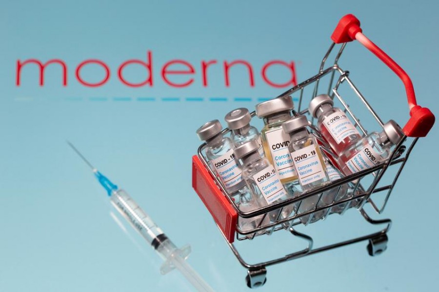 A small shopping basket filled with vials labelled "COVID-19 - Coronavirus Vaccine" and a medical sryinge are placed on a Moderna logo in this illustration taken on November 29, 2020 — Reuters/Files