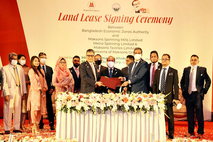 High officials of Maksons Group and Bangladesh Economic Zones Authority (BEZA) exchanging documents after signing land lease agreements at a city hotel on Monday