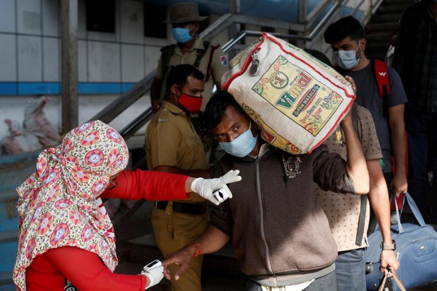 A health worker checks the pulse of a man at a railway station amidst the spread of the coronavirus disease (Covid-19) in Mumbai on December 4, 2020 — Reuters photo