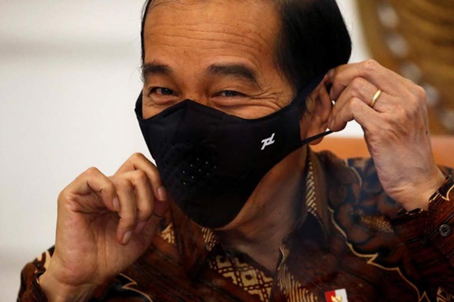 Indonesian President Joko Widodo reacting as he wears a protective mask during an interview at the Presidential Palace in Jakarta last month –Reuters file photo
