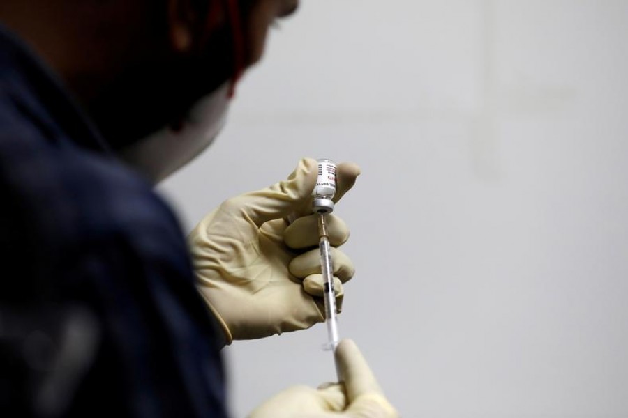 A medic fills a syringe with COVAXIN, an Indian government-backed experimental Covid-19 vaccine, before administering it to a health worker during its trials, at the Gujarat Medical Education and Research Society in Ahmedabad, India on November 26, 2020 — Reuters/Files