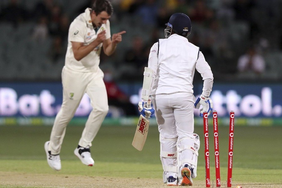 India's Prithvi Shaw, right, is bowled by Australia's Pat Cummins, left, on the second day of their cricket test match at the Adelaide Oval in Adelaide, Australia, Friday, December 18, 2020—AP Photo