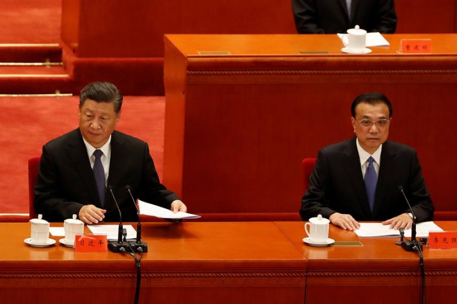 China's President Xi Jinping and Premier Li Keqiang take part in an event marking the 70th anniversary of the Chinese People's Volunteer Army's participation in the Korean War at the Great Hall of the People in Beijing, China October 23, 2020. REUTERS/Carlos Garcia Rawlins
