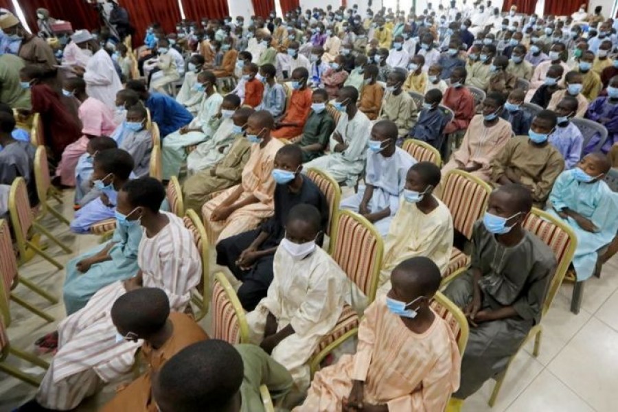 Rescued Nigerian school boys sit together at the Government house in Katsina, Nigeria, December 18, 2020 — Reuters