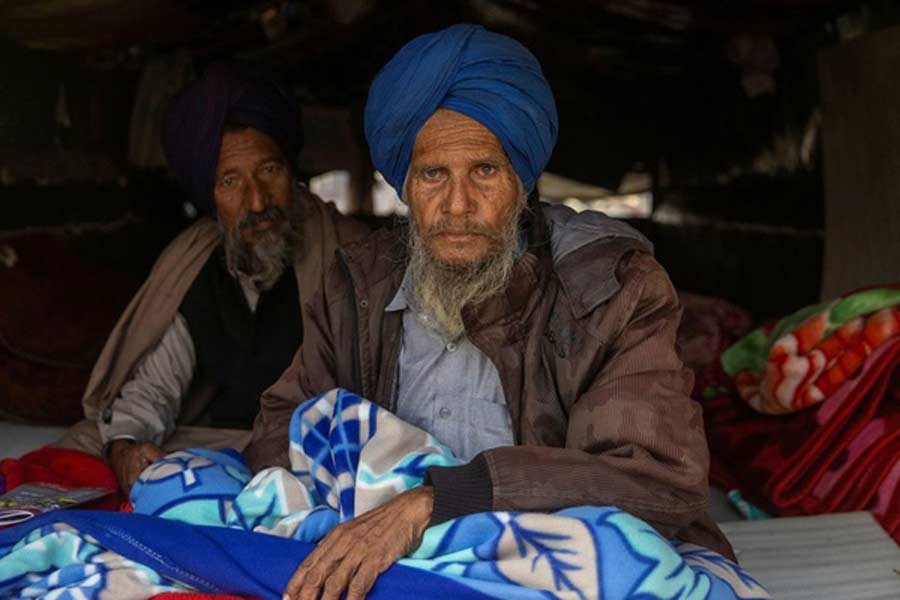 Farmer Paagh Singh, 76, sitting inside his tractor trolley on a cold winter morning at the site of a protest against new farm laws, at Singhu border, near New Delhi, on Monday –Reuters photo