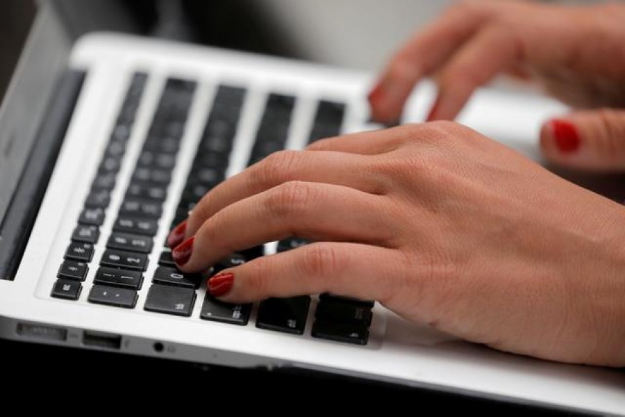 A person types on a laptop computer in Manhattan, New York City, US, September 11, 2020. REUTERS/Andrew Kelly