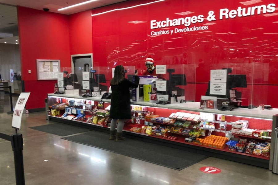 A customer is shown at the exchanges and return counter in a Target department store early Wednesday, Dec. 23, 2020, in Glendale, Colo. AP Photo/David Zalubowski