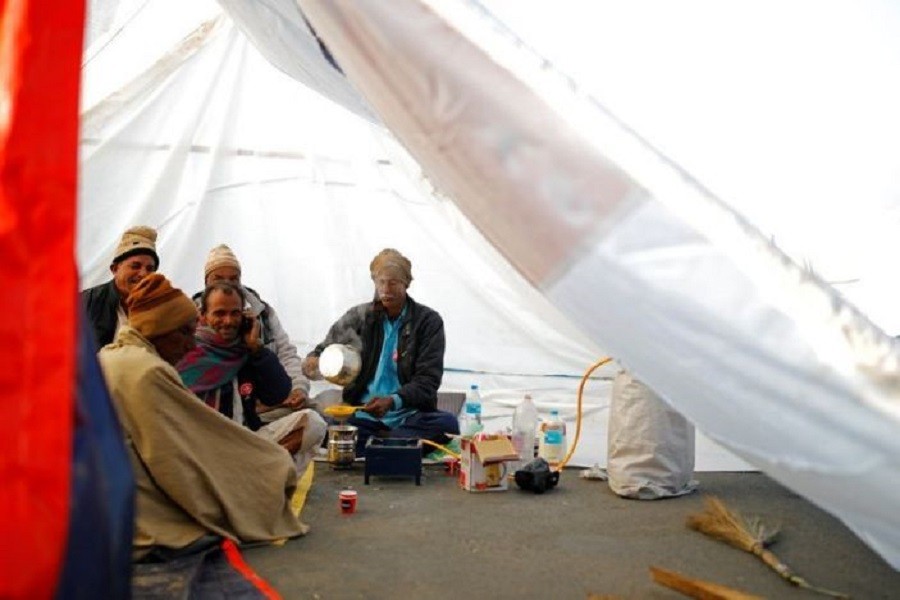Farmers make tea inside a tent at the site of a protest against new farm laws, at a state border on a national highway in Shahjahanpur, in the desert state of Rajasthan, near New Delhi, December 26, 2020 — Reuters