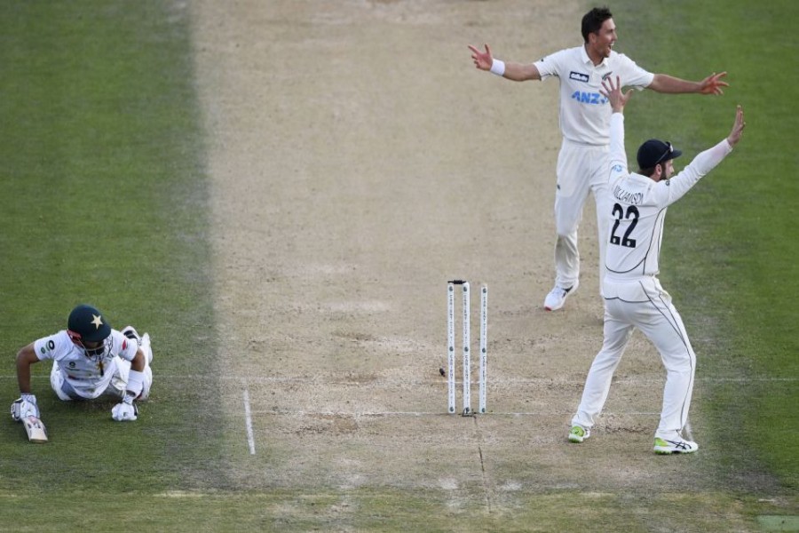 Pakistan captain Mohammad Rizwan, left, is run out after a direct throw by Mitchell Santner, not pictured, as Trent Boult and Kane Williamson, right, appeal during play on day three of the first cricket test between Pakistan and New Zealand at Bay Oval, Mount Maunganui, New Zealand, Monday, Dec. 28, 2020 - Andrew Cornaga/Photosport via AP