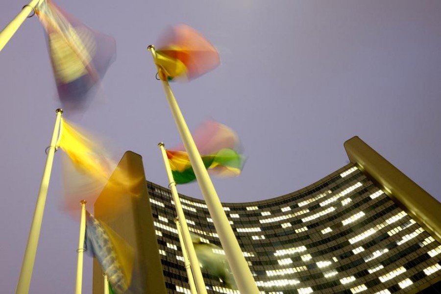 Flags flutter in the wind in front of the headquarters of the International Atomic Energy Agency (IAEA) in Vienna, Austria, December 16, 2020. REUTERS/Lisi Niesner
