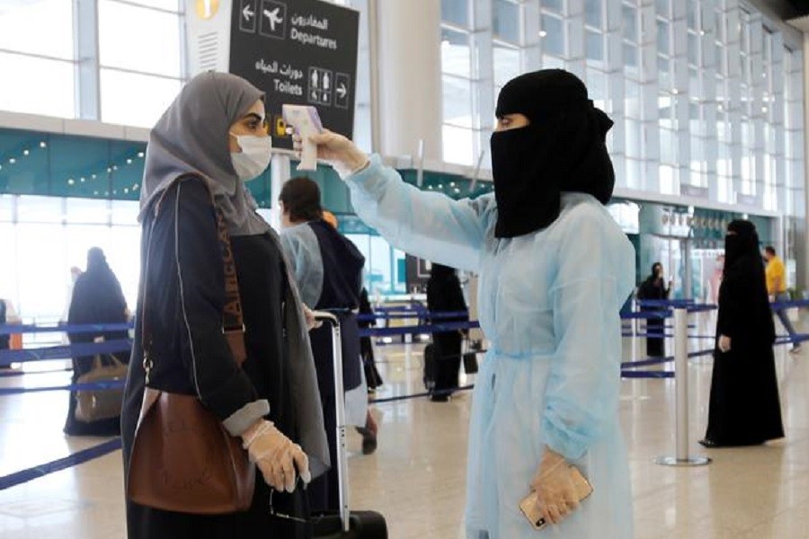 A security woman checks the temperature of a woman at Riyadh International Airport, after Saudi Arabia reopened domestic flights, following the outbreak of the coronavirus disease (Covid-19), in Riyadh, Saudi Arabia, May 31, 2020 — Reuters/Files
