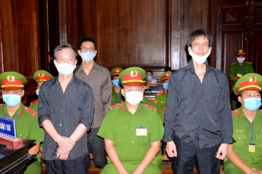(Standing, from left) Nguyen Tuong Thuy, Le Huu Minh Tuan and Pham Chi Dung were found guilty of spreading anti-state propaganda.PHOTO: AFP