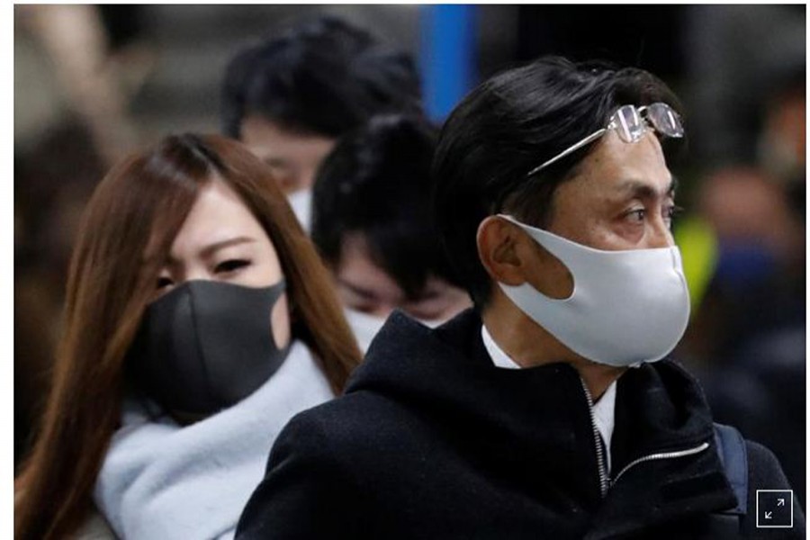Pedestrians wearing protective masks, following the coronavirus disease (COVID-19) outbreak, walk out of a station during a commuting hour at a business district in Tokyo, Japan, January 7, 2021. REUTERS/Kim Kyung-Hoon