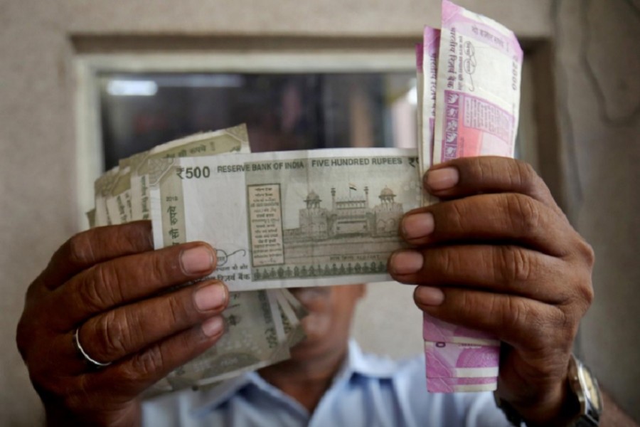 A cashier checks Indian rupee notes inside a room at a fuel station in Ahmedabad, India, September 20, 2018 - Reuers file photo