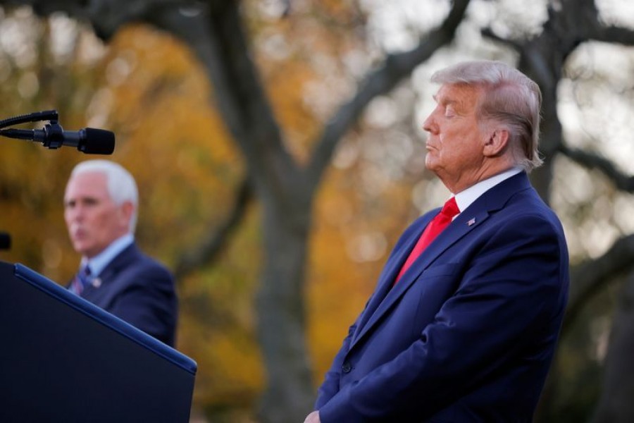 US President Donald Trump listens to Vice President Mike Pence speak during an event about the "Operation Warp Speed" programme, the joint Defense Department and HHS initiative that has struck deals with several drugmakers in an effort to help speed up the search for effective treatments for the ongoing coronavirus disease (Covid-19) pandemic, in the Rose Garden of the White House in Washington, US on November 13, 2020 — Reuters/Files