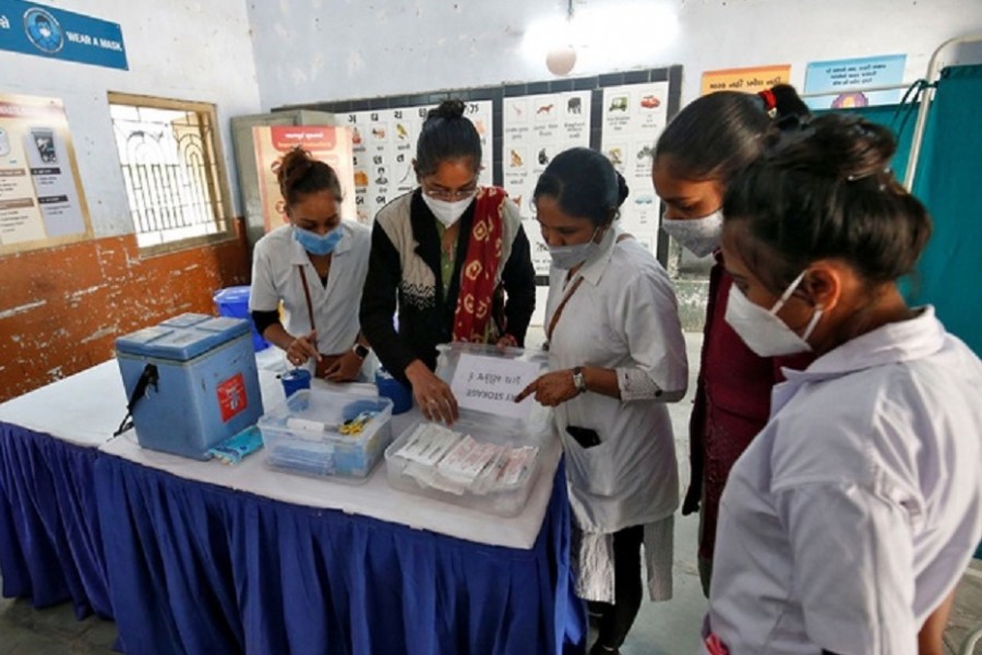Health workers prepare a vaccination room inside a classroom of a school, which has been converted into a temporary COVID-19 vaccination centre in Ahmedabad, India, January 4, 2021. Reuters
