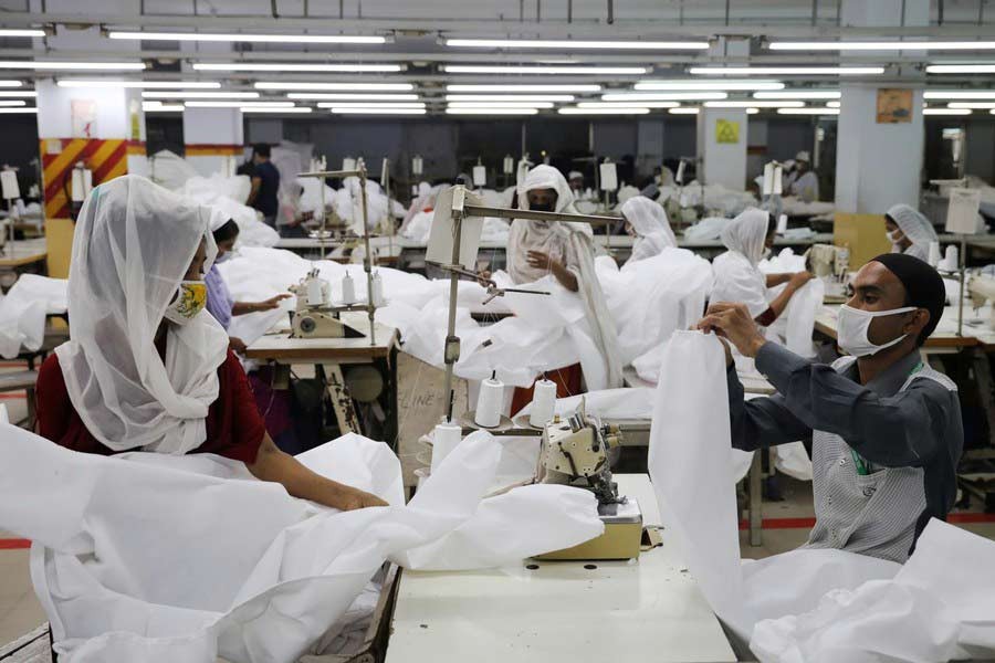 Garment workers making protective suit at a factory in Dhaka amid the coronavirus outbreak —Reuters file photo