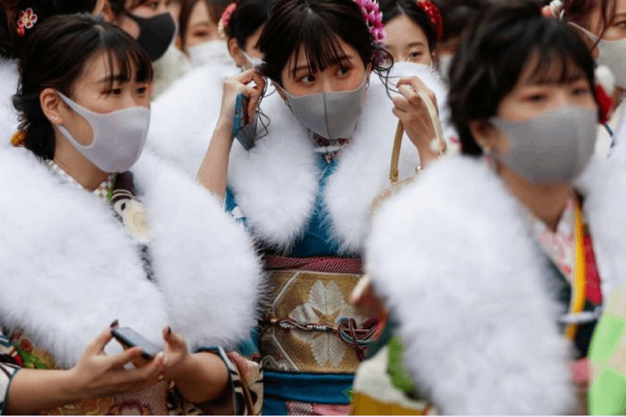 Kimono-clad youth wearing protective face masks leave their Coming of Age Day celebration ceremony at Yokohama Arena during the government declared the second state of emergency for the capital and some prefectures, amid the coronavirus disease (COVID-19) outbreak, in Yokohama, south of Tokyo, Japan January 11, 2021. REUTERS/Issei Kato