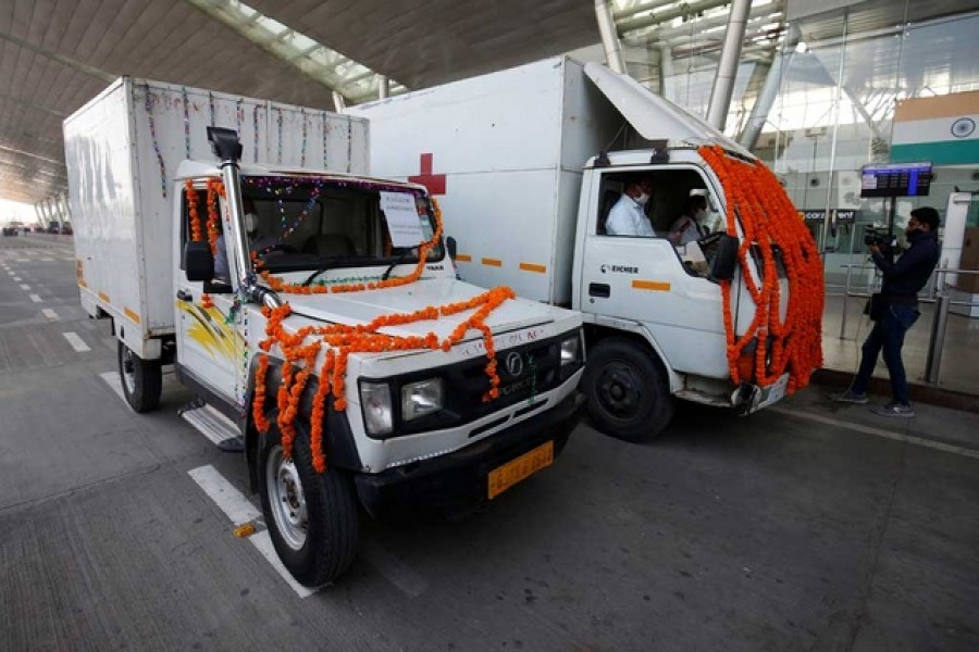 Vehicles containing COVISHIELD, a coronavirus disease (Covid-19) vaccine manufactured by Serum Institute of India, leave the airport after a consignment of the vaccines arrived from the western city of Pune for its distribution, in Ahmedabad, India, January 12, 2021. REUTERS