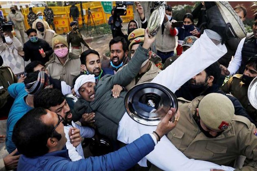Police officers detain an activist of the youth wing of India's main opposition Congress party during a protest against new farm laws in New Delhi, India Jan 12, 2021. REUTERS   
