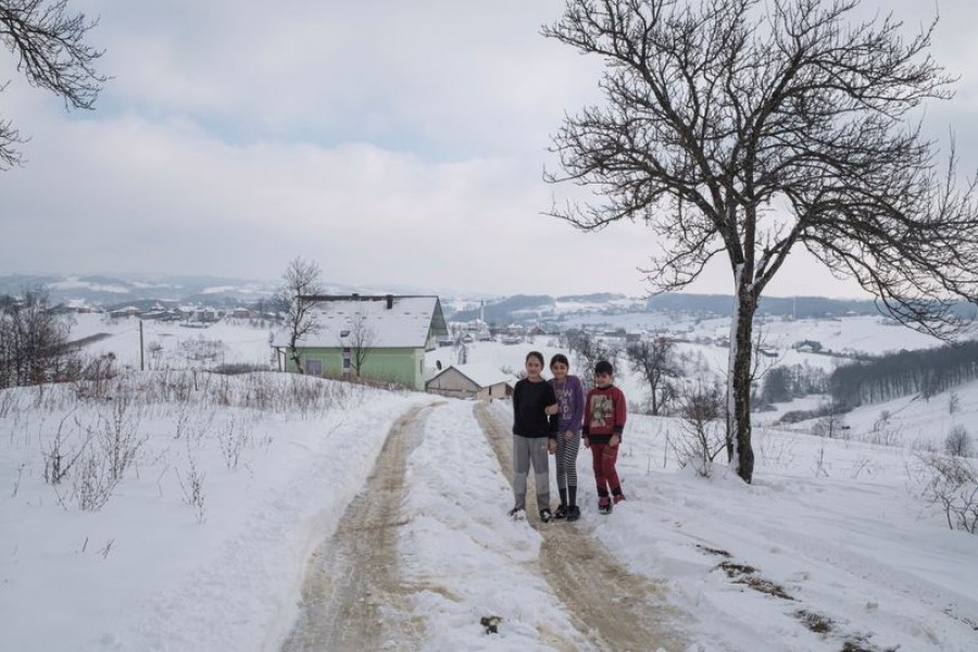 Zeinaf Jabar, a migrant from Iraq, stands with two other kids from Afghanistan near an abandoned house where they live, in the village of Hadzin Potok near the northwestern town of Velika Kladusa, Bosnia and Herzegovina, January 12, 2021 — Reuters photo