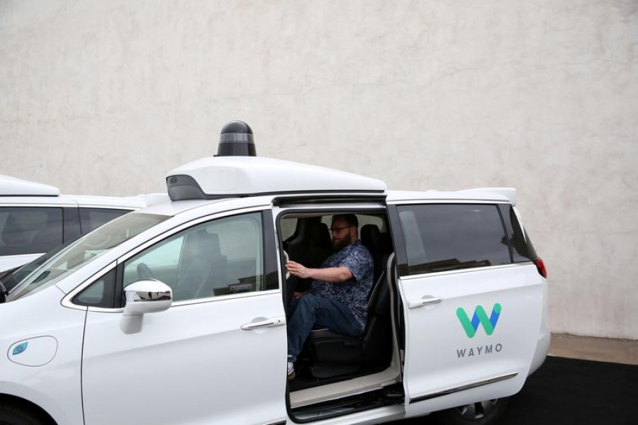 Early rider Alex Hoffman seen inside a Waymo self-driving vehicle, during a demonstration in Chandler, Arizona on November 29, 2018 — Reuters/Files