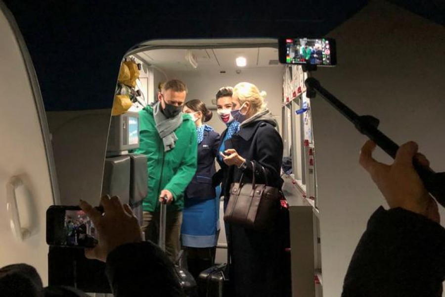Russian opposition leader Alexei Navalny and his wife Yulia Navalnaya walk out of a plane after arriving at Sheremetyevo airport in Moscow, Russia, January 17, 2021— Reuters