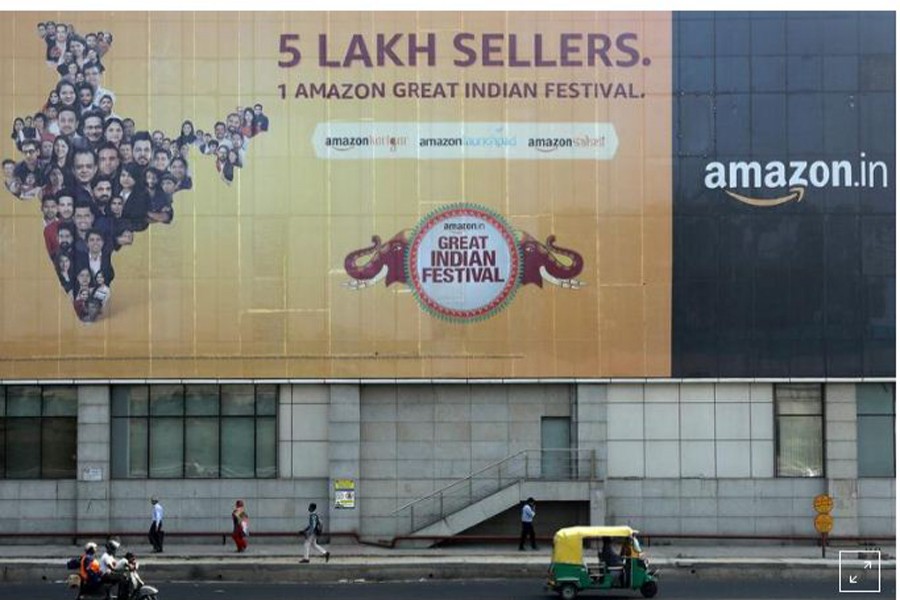 FILE PHOTO: People move past a hoarding of Amazon India outside a metro rail station in New Delhi, India, October 23, 2019. REUTERS/Anushree Fadnavis