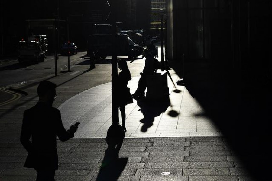 The early morning sun silhouettes commuters as they make their way through Canary Wharf in London, Britain on September 5, 2019 — Reuters/Files