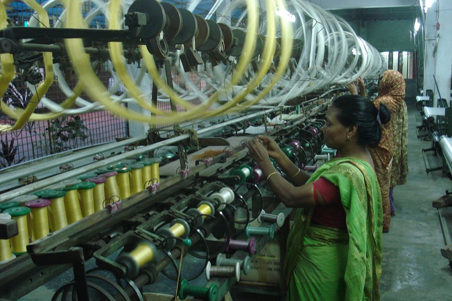 Workers remain busy at a silk factory in Rajshahi — File photo