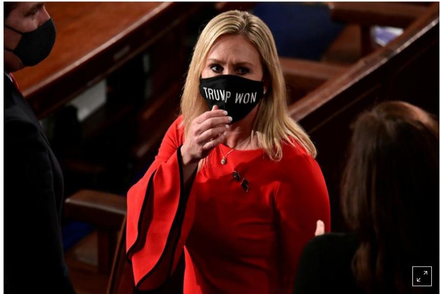 FILE PHOTO: US Rep. Marjorie Taylor Greene (R-GA) wears a "Trump Won" face mask as she arrives on the floor of the House to take her oath of office as a newly elected member of the 117th House of Representatives in Washington, U.S., January 3, 2021. REUTERS/Erin Scott/Pool/File Photo