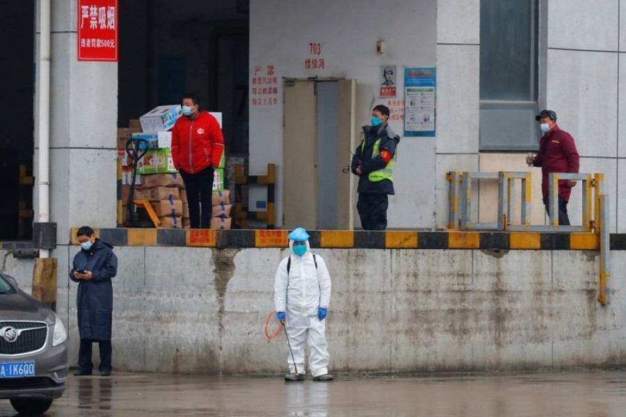 A worker in PPE stands in Baishazhou market during a visit of World Health Organization (WHO) team tasked with investigating the origins of the coronavirus (Covid-19) pandemic, in Wuhan, Hubei province, China on January 31, 2021 — Reuters photo