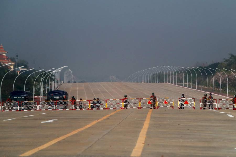 Myanmar's soldiers stand guard at a barricaded road leading to the parliament building in Naypyitaw on Tuesday -AP Photo