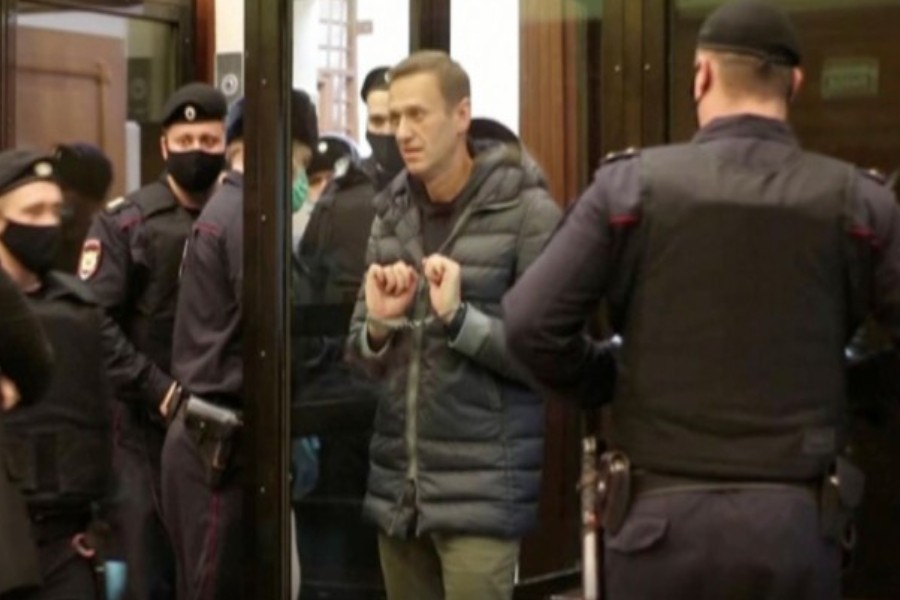 A still image taken from video footage shows Russian opposition leader Alexei Navalny in handcuffs, who is accused of flouting the terms of a suspended sentence for embezzlement, before a court hearing in Moscow, Russia February 2, 2021. Press service of Moscow City Court/Handout via Reuters TV