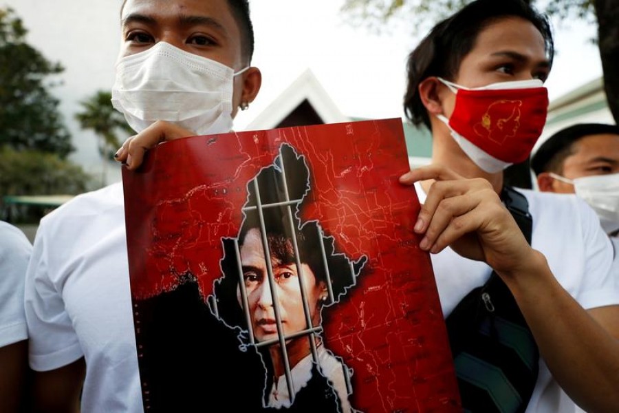 Myanmar citizens hold up a picture of leader Aung San Suu Kyi after the military seized power in a coup in Myanmar, outside United Nations venue in Bangkok, Thailand on February 2, 2021 — Reuters/Files