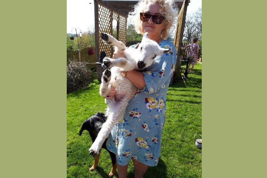 Bev Francis-Green holds a lamb in Carlisle, Britain in April, 2020. Bev Francis-Green/Handout via REUTERS