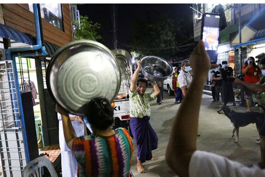 Local people bang pans the way they traditionally do it to drive away evil spirits, as they protest against military coup in Yangon, Myanmar February 03, 2021. REUTERS