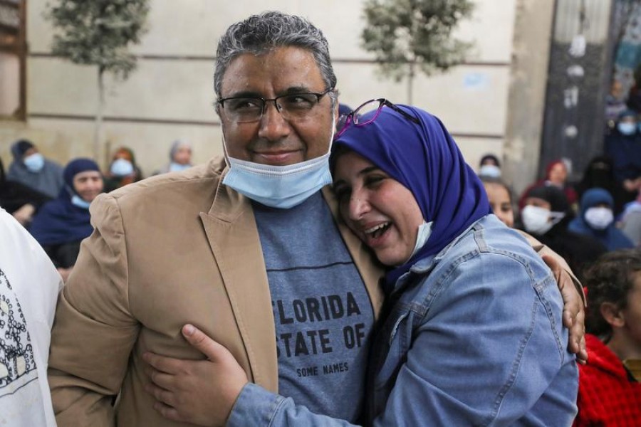 Journalist Mahmoud Hussein embraces with his daughter after being released by Egyptian authorities after four years in detention on accusations of publishing false news, in Abou Al Nomros, in Giza, Egypt on February 6, 2021 — Reuters photo