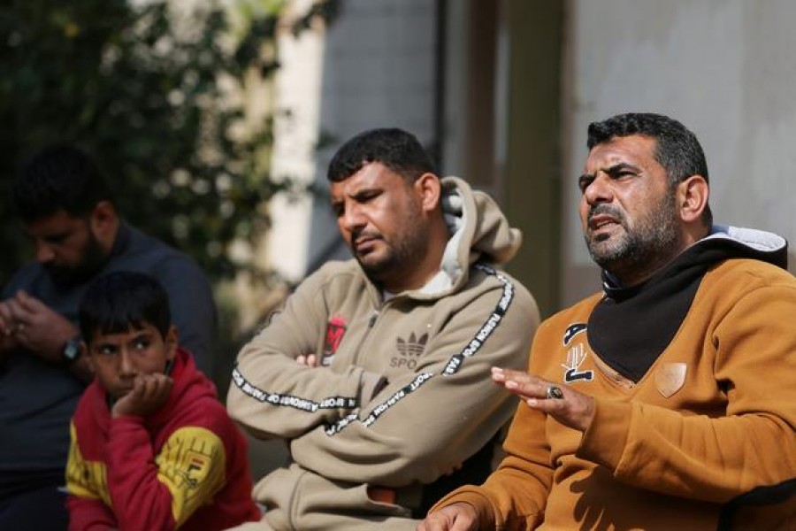 Palestinians from Abu Jama family sit outside their house in Khan Younis in the southern Gaza Strip February 6, 2021. REUTERS/Ibraheem Abu Mustafa