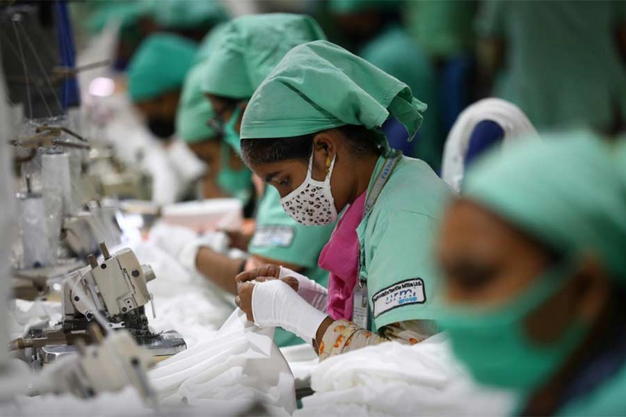 Garment employees work in a sewing section of a textile factory in Gazipur on Sunday -Reuters Photo