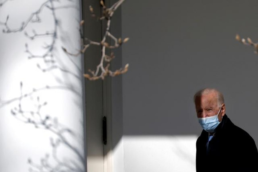 FILE PHOTO: US President Joe Biden walks into the Oval Office in Washington, US, February 8, 2021. REUTERS/Carlos Barria/File Photo