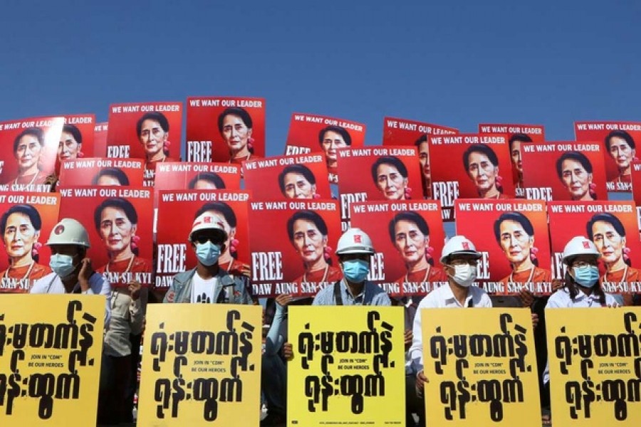 Demonstrators hold placards with the image of Aung San Suu Kyi during a protest against the military coup, in Naypyitaw, Myanmar, February 15, 2021 — Reuters/Files
