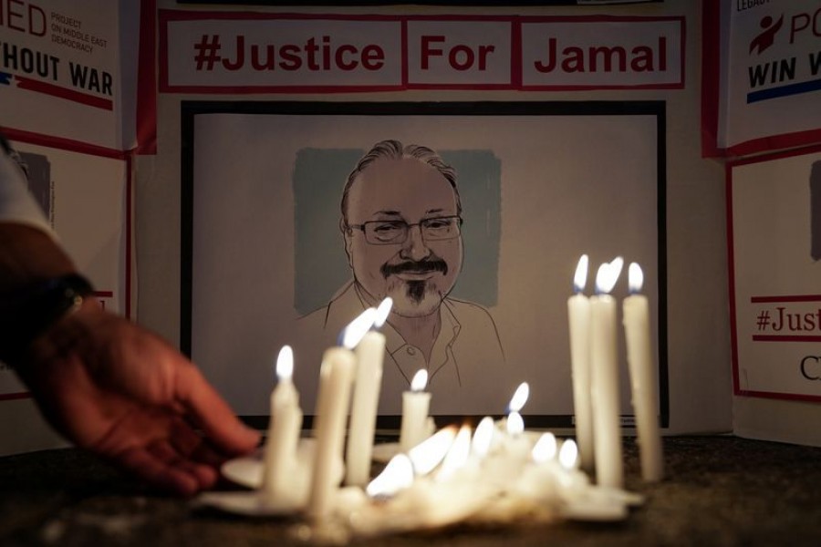 FILE PHOTO: The Committee to Protect Journalists and other press freedom activists hold a candlelight vigil in front of the Saudi Embassy to mark the anniversary of the killing of journalist Jamal Khashoggi at the kingdom's consulate in Istanbul, Wednesday evening in Washington, US, October 2, 2019. REUTERS/Sarah Silbiger